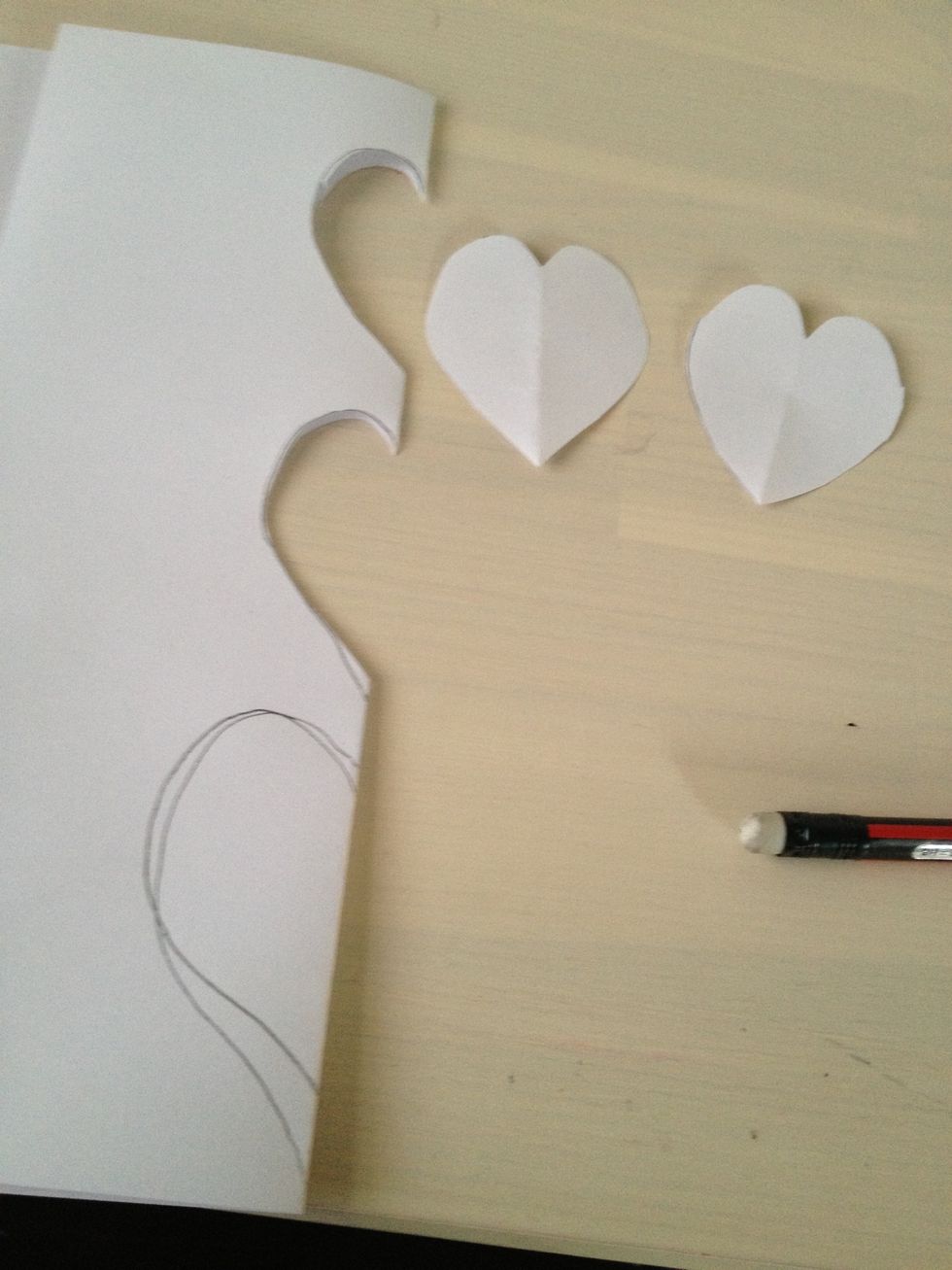 Fold your paper and draw some hearts. Then cut them out and pick the best one.