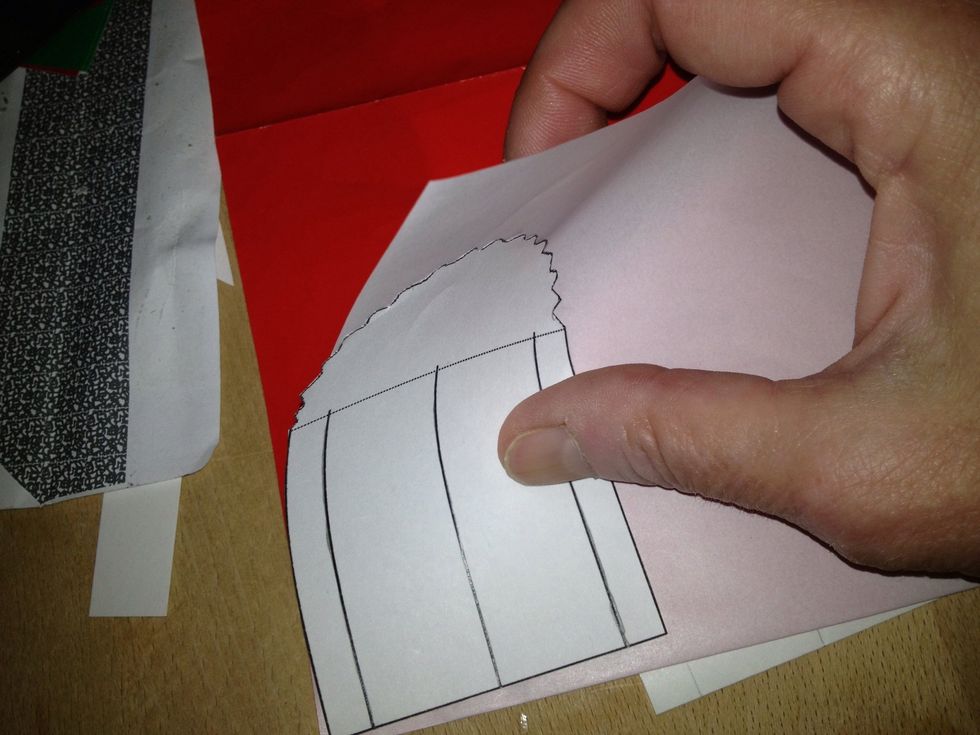 Fold your paper in half backside out. Place your templates straight edge along the fold.
