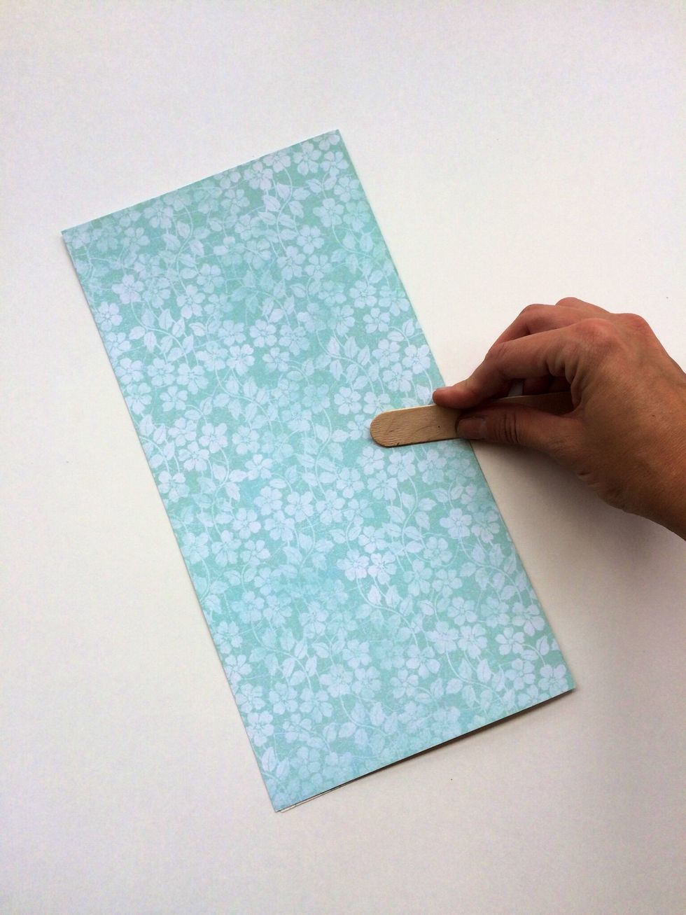 Fold your paper in half. Create well. (Good creases will help your project hold together and lay flatter.) Make sure that the pattern you want your dress to be is on the outside.