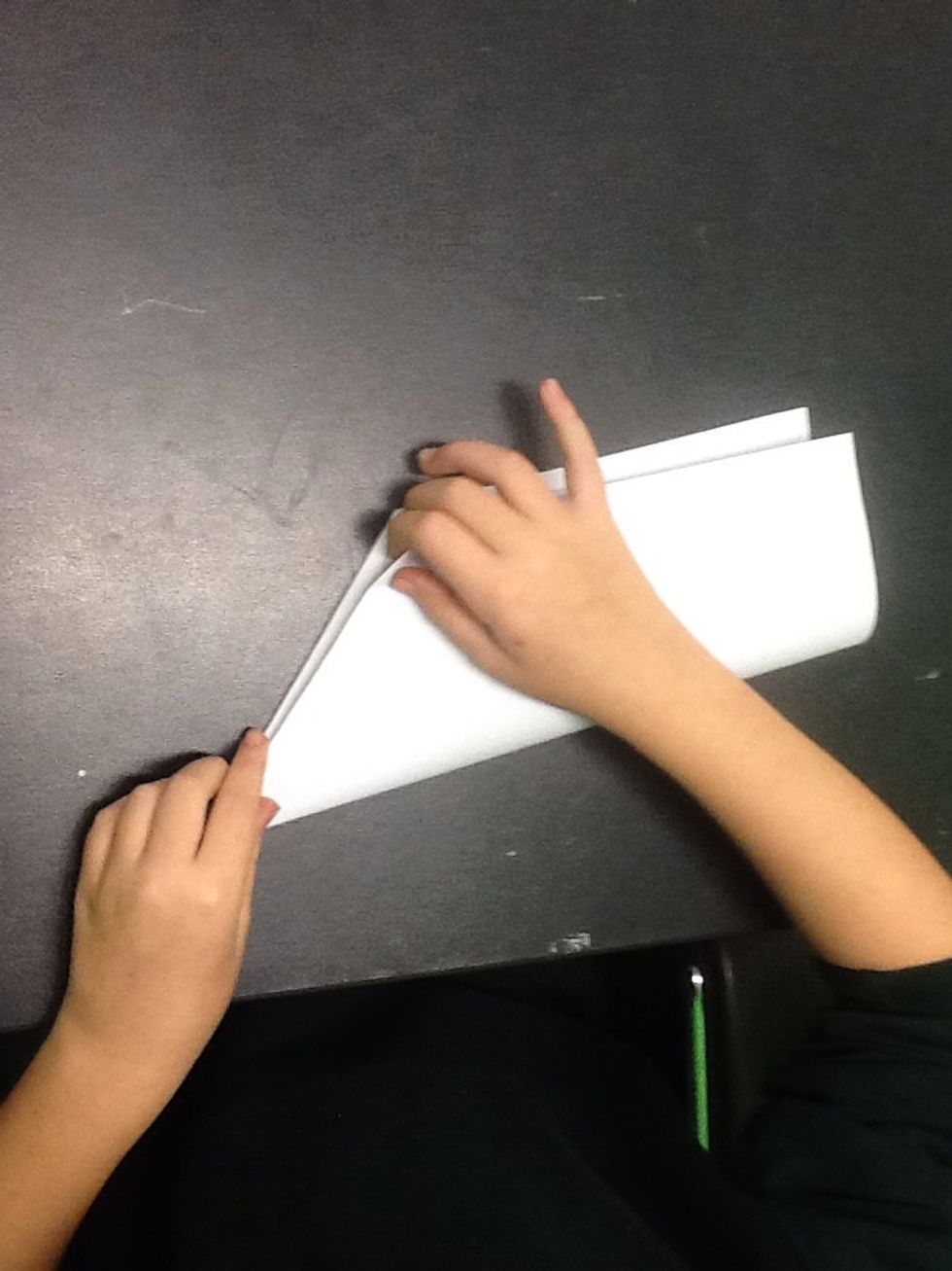 Fold your piece of paper back in half so both folded sides are facing each other