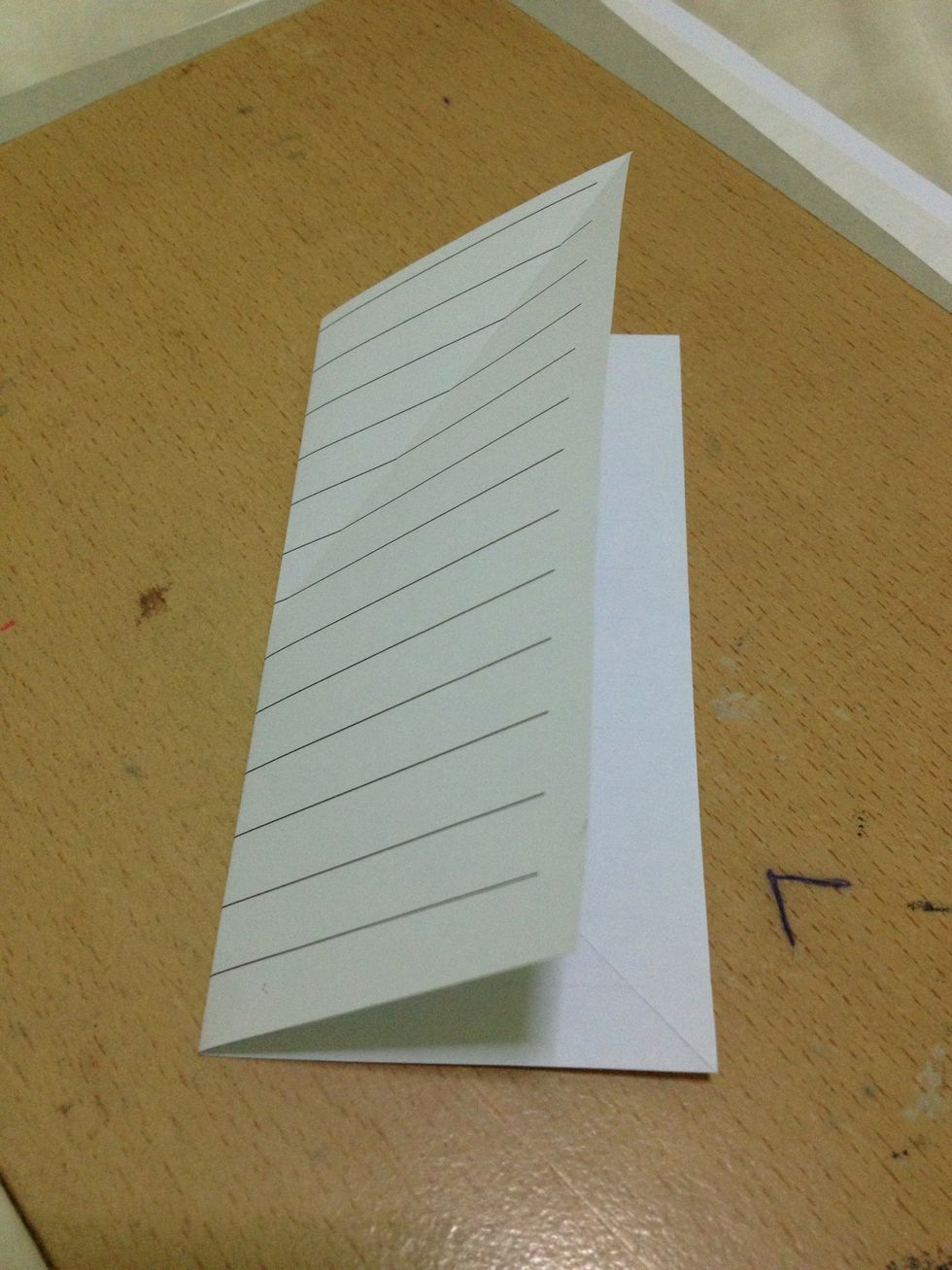 Fold your square sheet of paper in half and unfold.