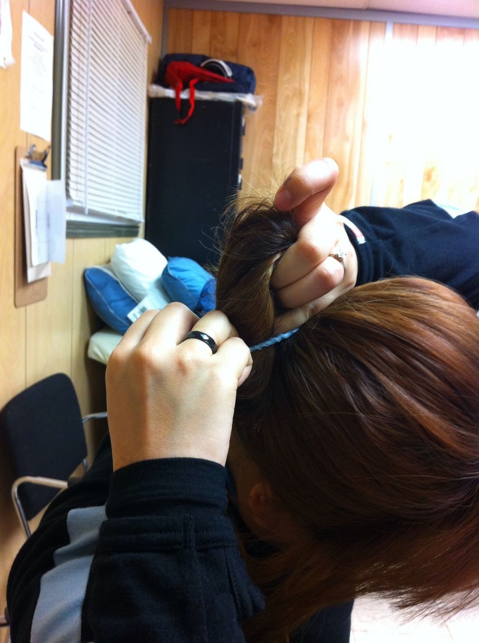 Folder twisted hair in half and tie it with elastic band