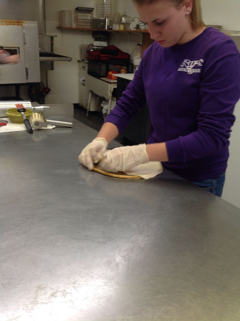 Folding ends of dough over screen