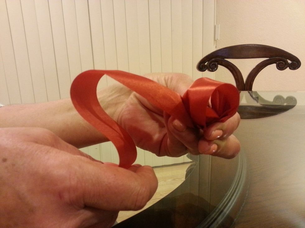 Folding ribbon back makes your first loop, gather at center