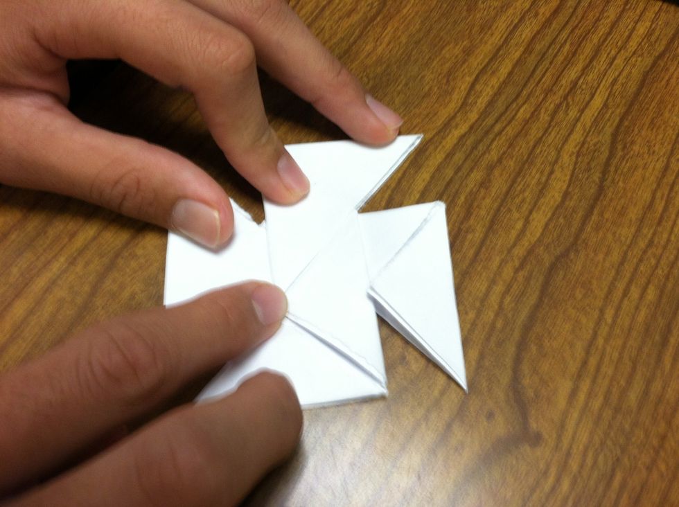 Follow closely! Now, fold the corners into the pockets and keep folding the corners into the pockets.