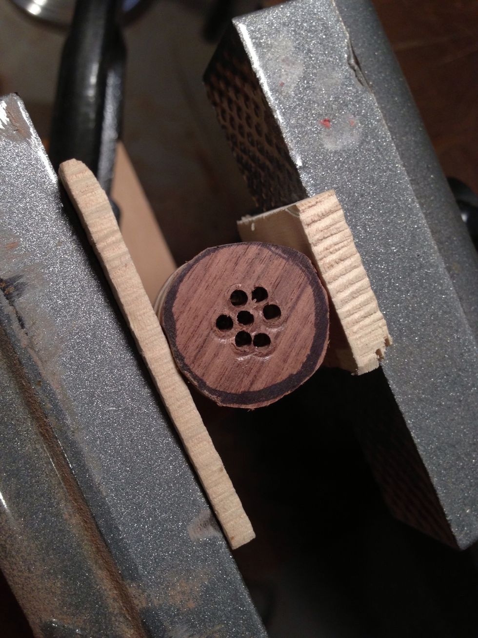 Follow pattern with small holes so you don't split wood. You can go larger drill bit after this or keep going.