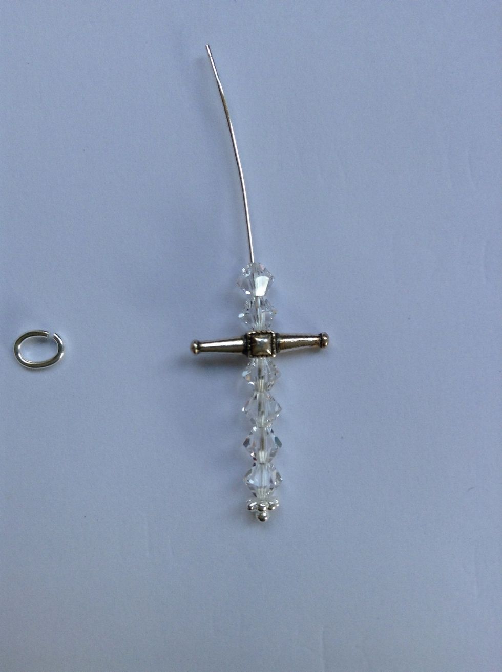 Follow steps outlined by beadandbutton.com. Cut leaving 3/8 ". Make a smooth loop. Attach oval jump ring.