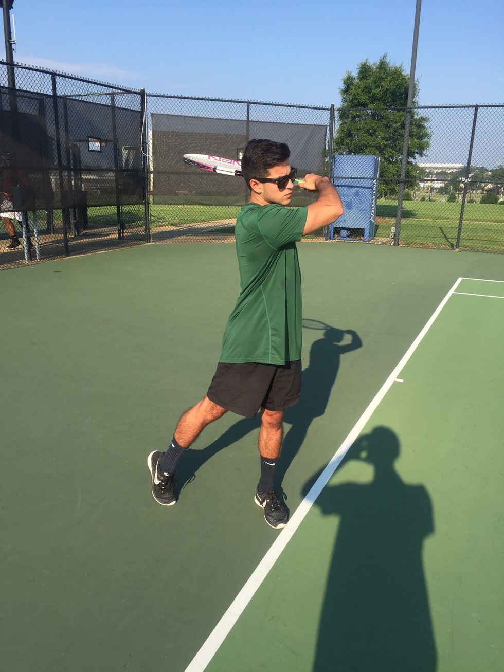 Follow Through: hips and shoulders rotate fully, positioning the body towards the net. Swing the racquet upward across the body, ending above head level.