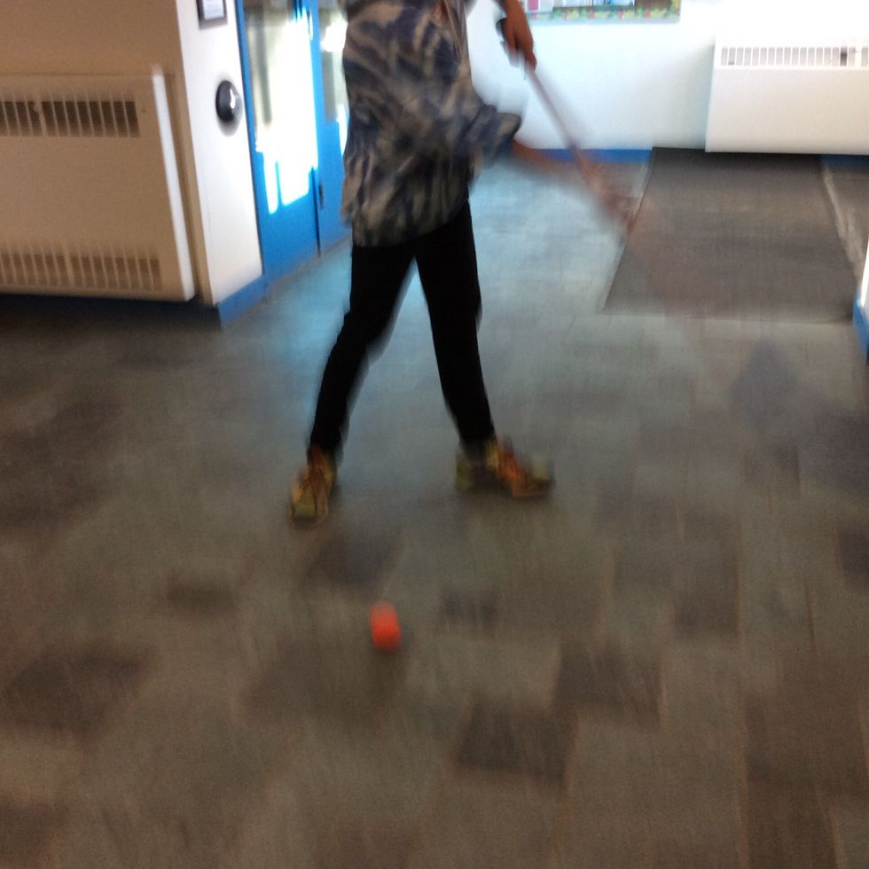 Follow through with your shot and shoot the puck, aiming towards the net.