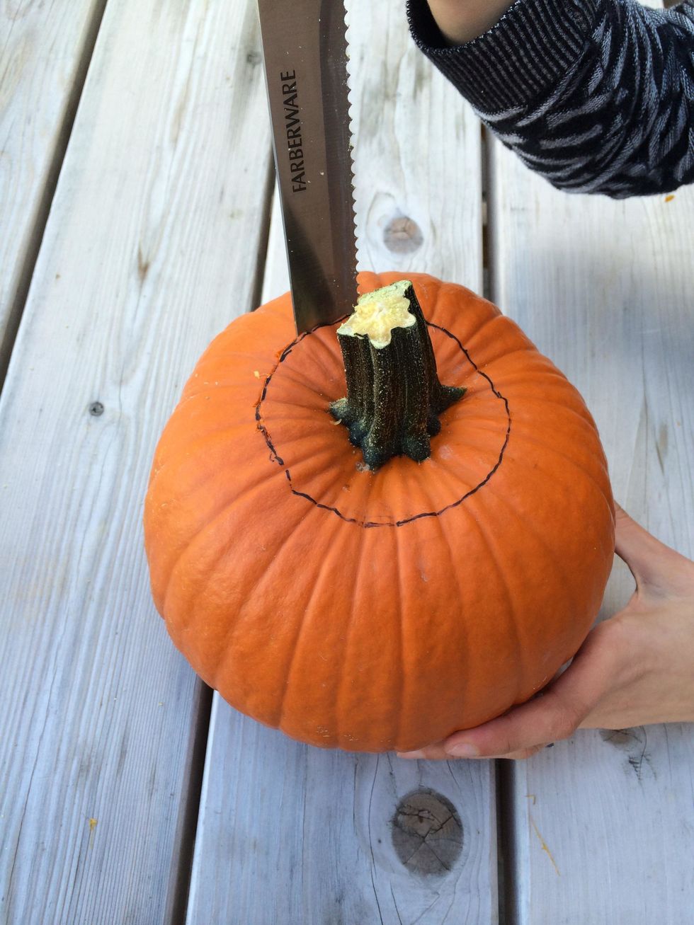 Following the inside line, carve out the top of the pumpkin.