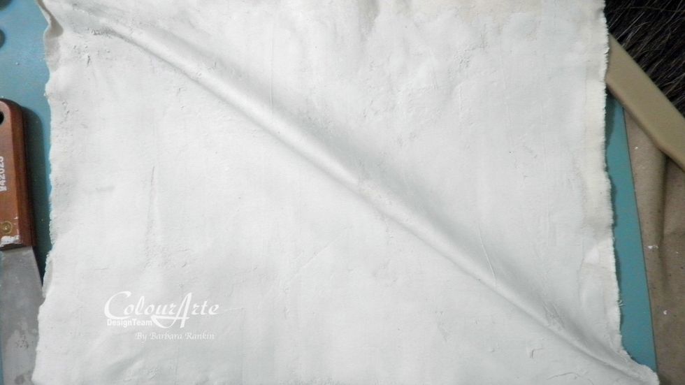 For a grungier look, you can pull the muslin on the bias (diagonal) in each direction. This will release some of the joint compound from the fabric, giving a really cool texture.