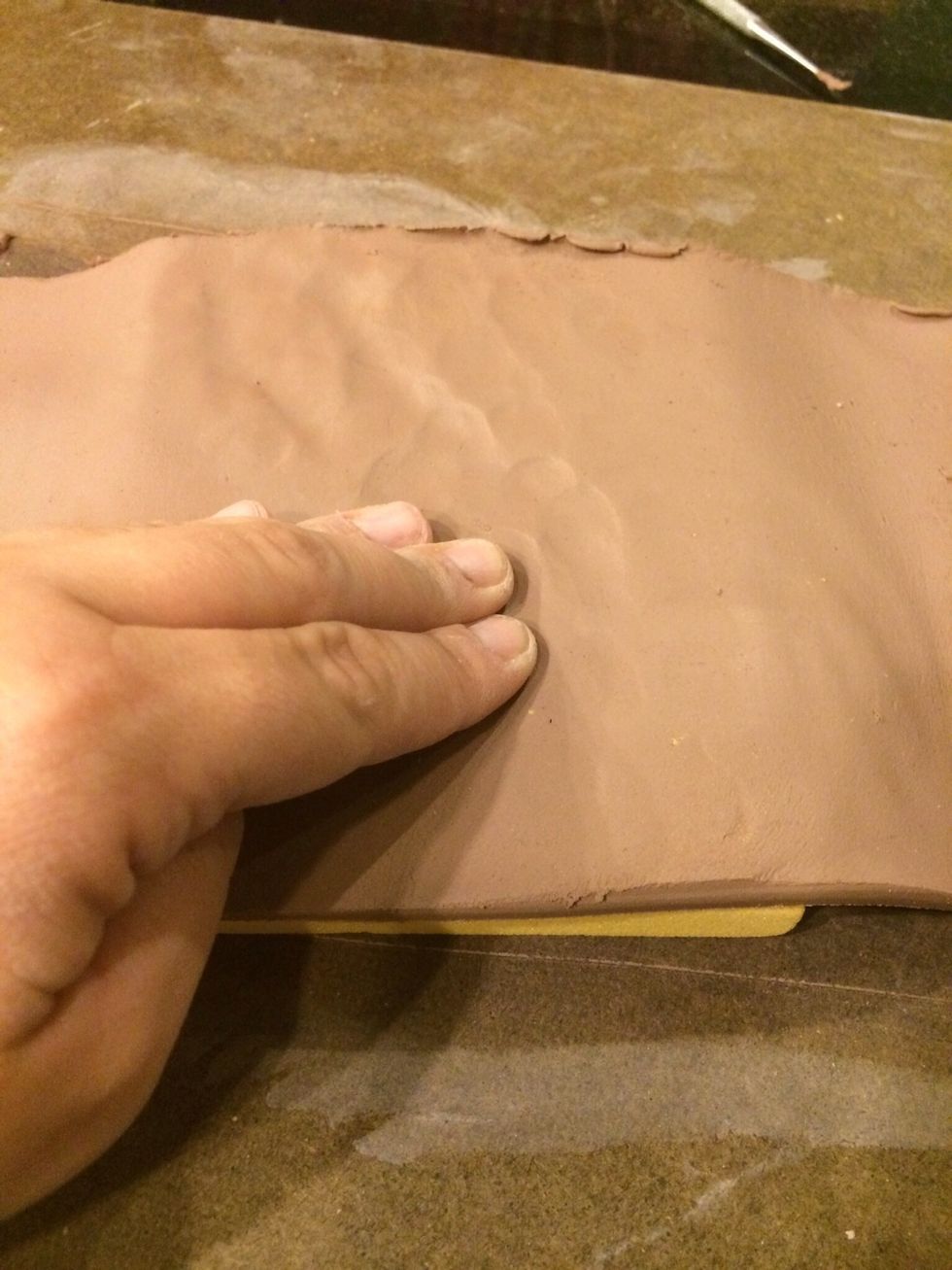 For a mold that is carved into lay your clay on top of the carved foam mold and press the clay onto the foam gently.