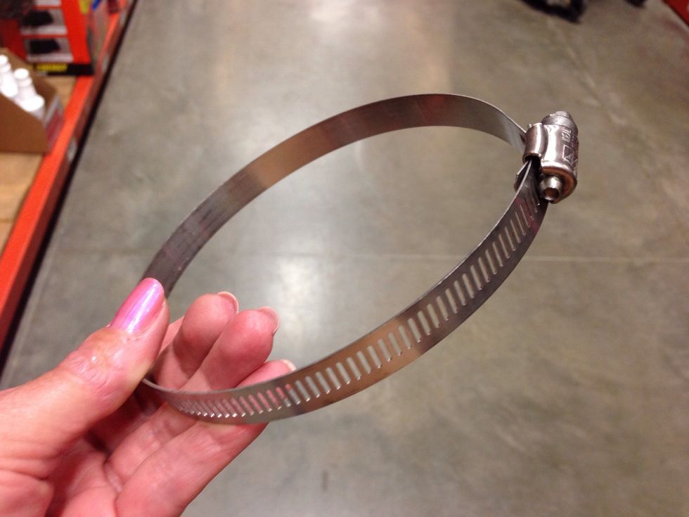 For a wooden post, get plumbing band clamps that will fit your flower pots. I used about 5 inch clamps for 6 inch pots. Paint clamps to blend into the pots or keep the steel look.