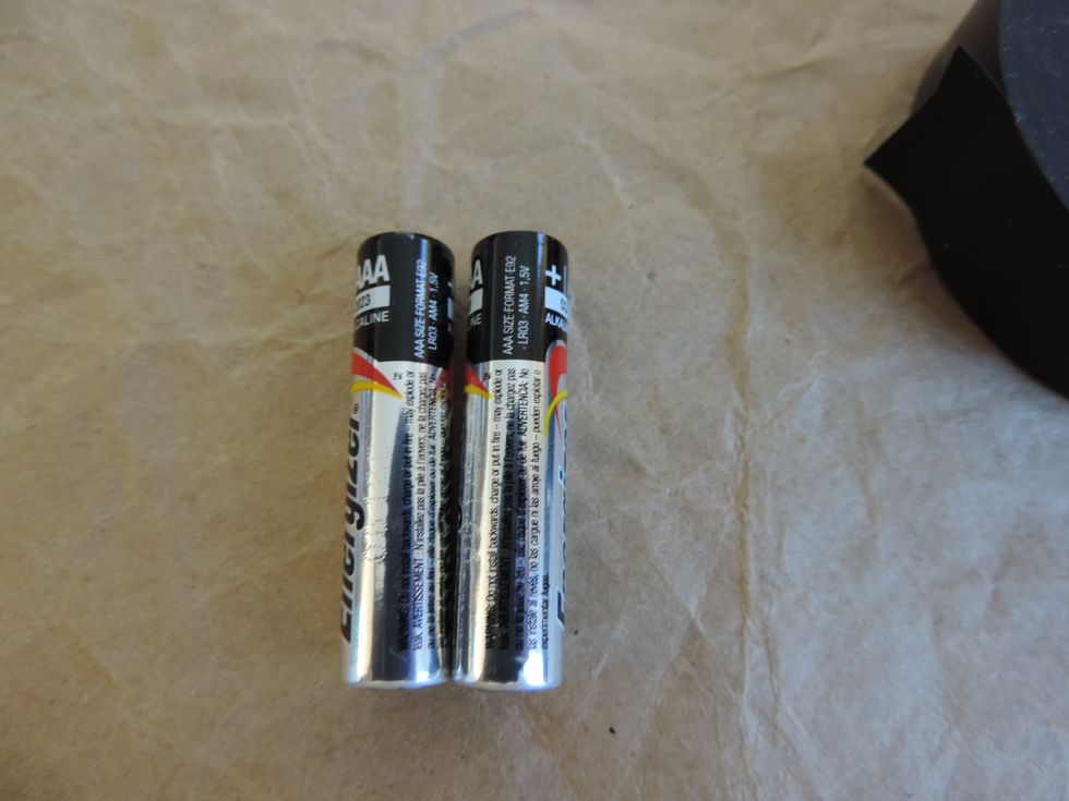 For AAA and AA batteries, set them side by side and line up the charges.