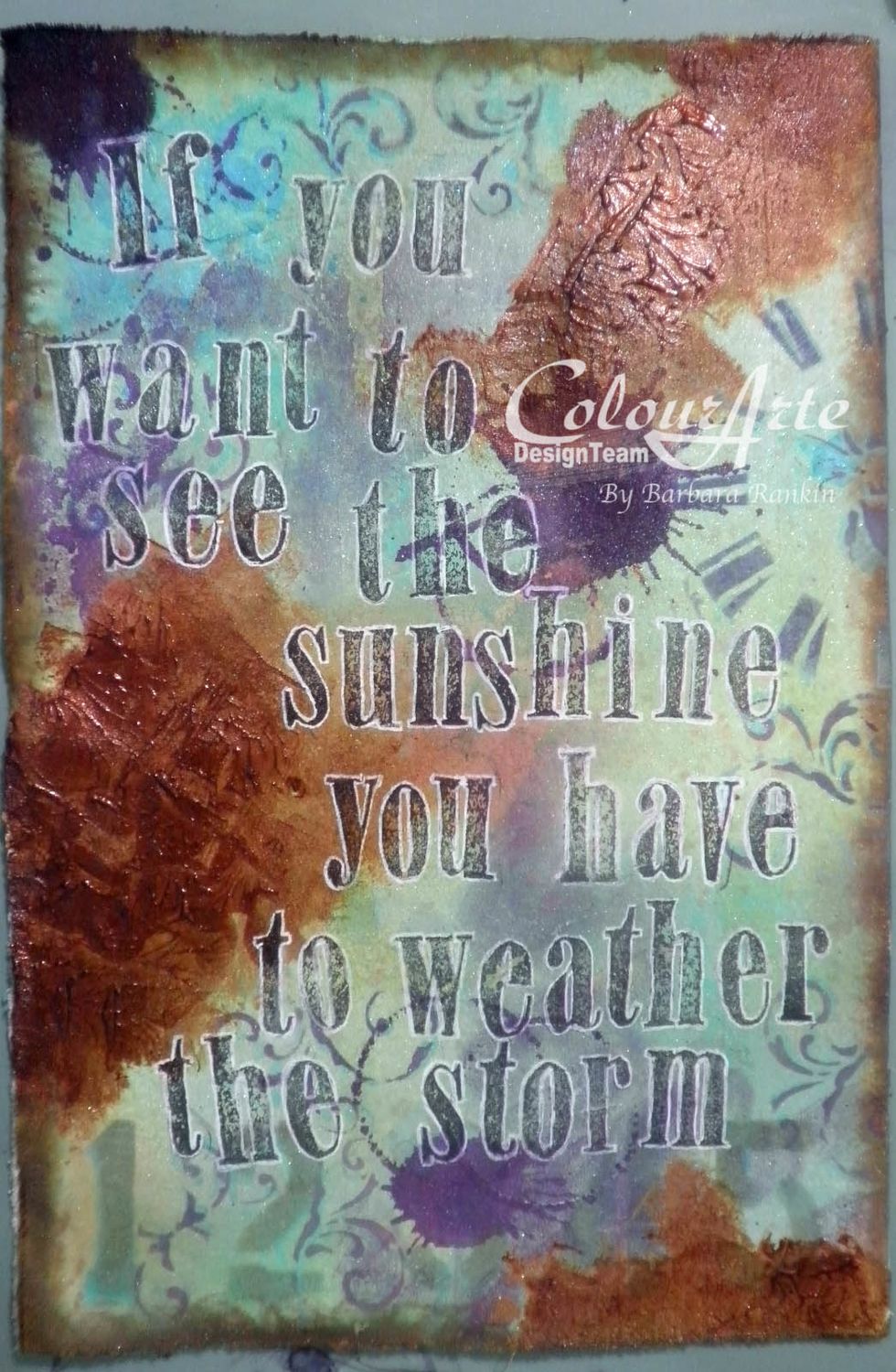 For added color strength, spray ColourArte Key Lime Radiant Rain shimmering mist over the page, adding a bit of Mediterranean color, and making splats with the Wine & Roses Color Concentrate dauber.