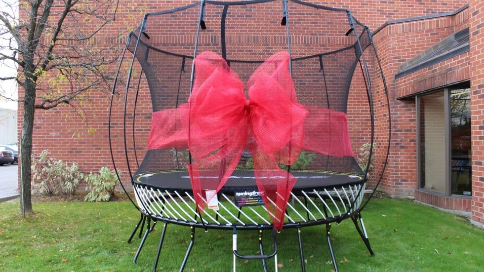 For an extra touch wrap the ribbon around your trampoline net.  Use wire to attach either end of the ribbon to the center of your bow once it\u2019s wrapped around the net.