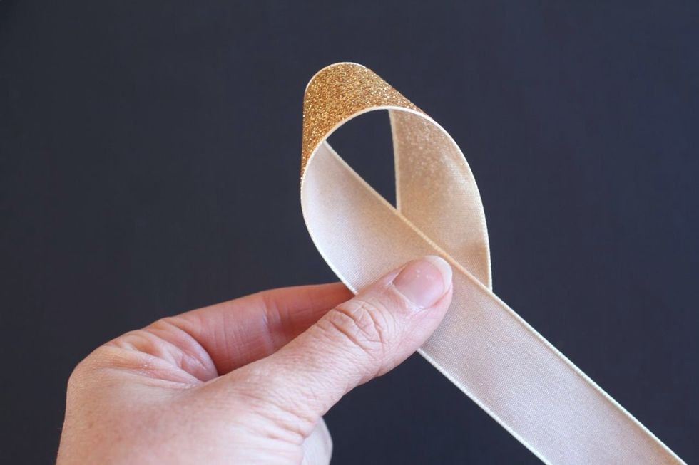 For each piece of ribbon, loop the end back around to the center. The pretty side should be facing away from you as you do it.