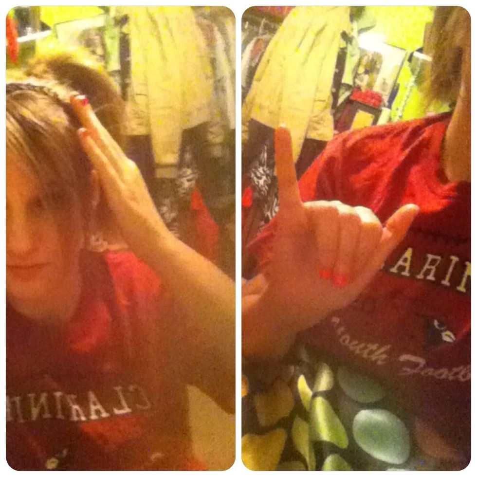 For "gold," touch your head, (left photo,) then bring your hand down & shake the letter "Y" back and forth. (Right photo.)