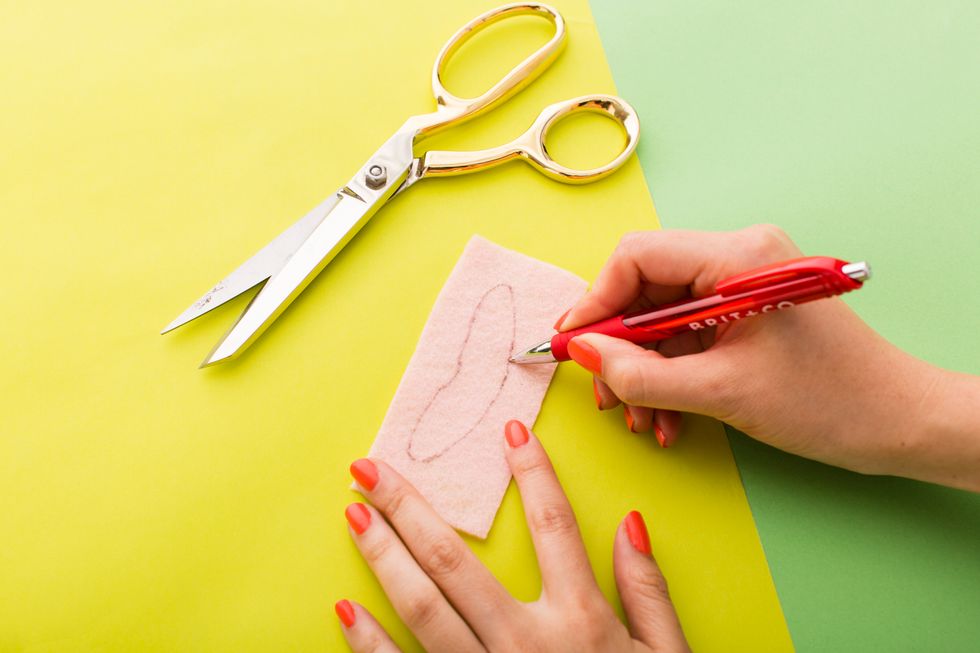For Judy\u2019s nose, cut out a small thin piece of pink felt.