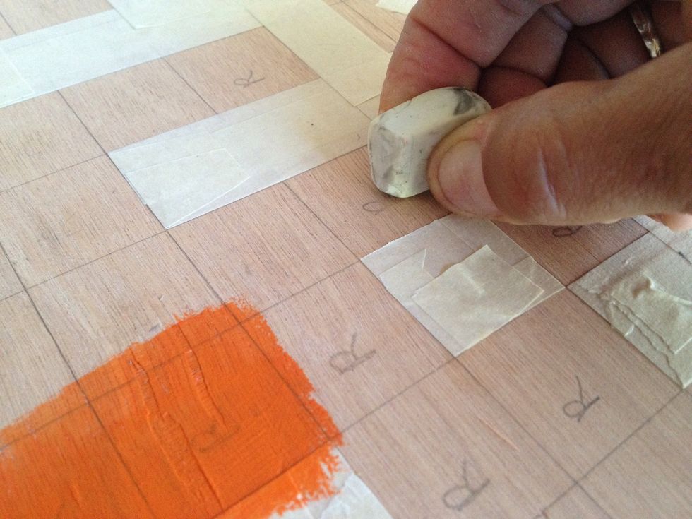 For lighter colors (anything that's not black) you'll want to erase the pencil markings before painting, to prevent them from showing through like the "R" in this picture.