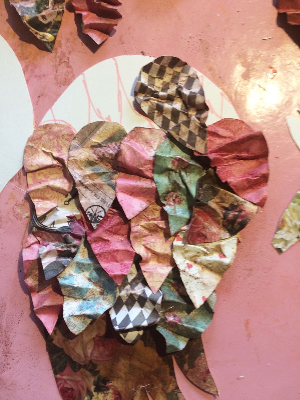 For me, it took about 3 layers of larger feathers to fill the majority of my wing. Once I reached the top, I angled my feather slightly to go with the curve of the top of the wing.