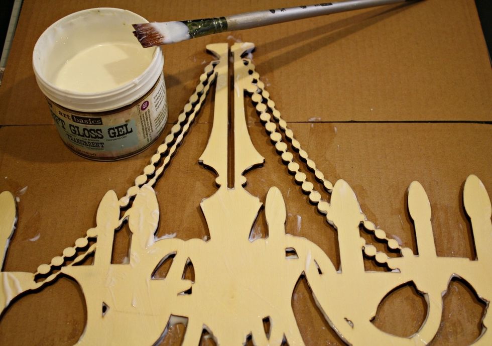 For my chandelier I chose Art Basics-Soft Gloss Gel to do an image transfer. Using a paintbrush add lots of gloss gel, making sure the entire wooden chandelier piece is covered.