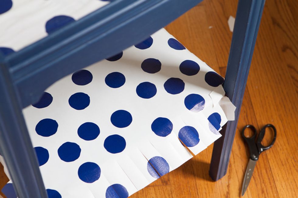 For open shelf, cut the paper about 3 inches larger all around so you have excess paper that can be wrapped around the edge and secured underneath. This will give the edge a finished look.
