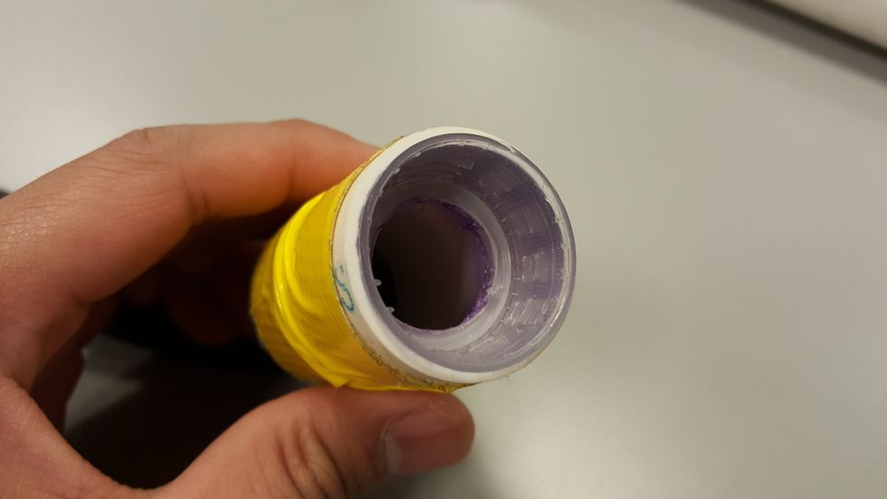 For other end of the inner tube, attach a 3" long PVC tube with duct tape. Next, glue a bottle cap with a big hole into the 3" PVC tube as shown above. This will allow you to replace a broken bottle