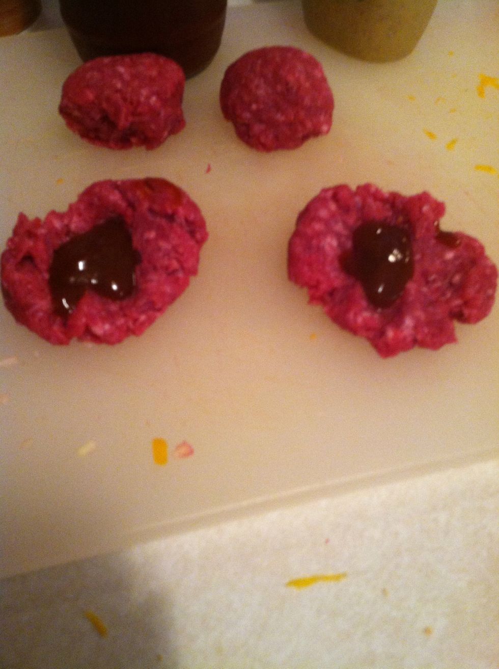 For sauces that you are adding, press a thumb into the ball, add the sauce, and start folding it in.