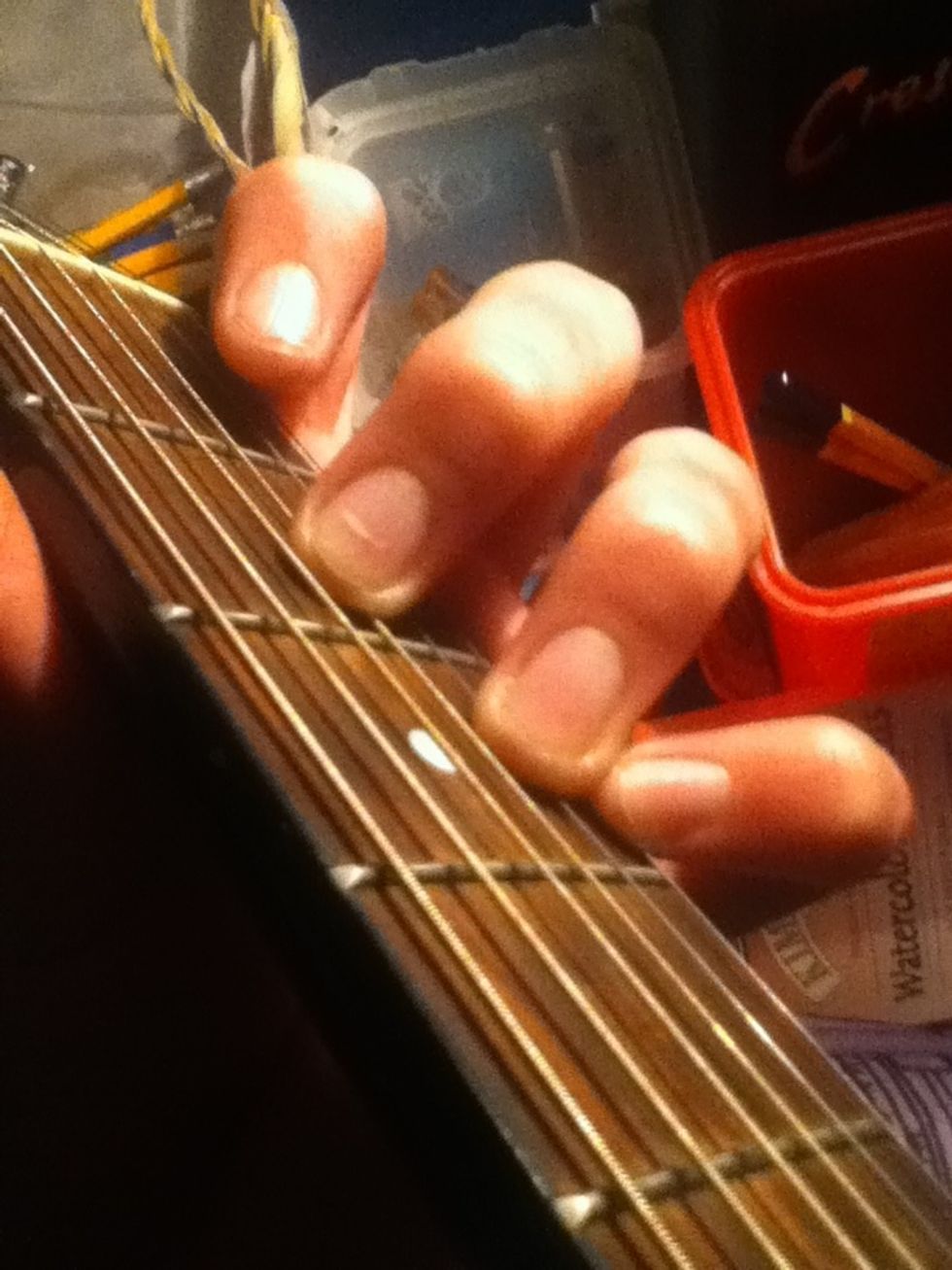 For some people it may be easier to use the middle finger but I'd suggest the first finger.