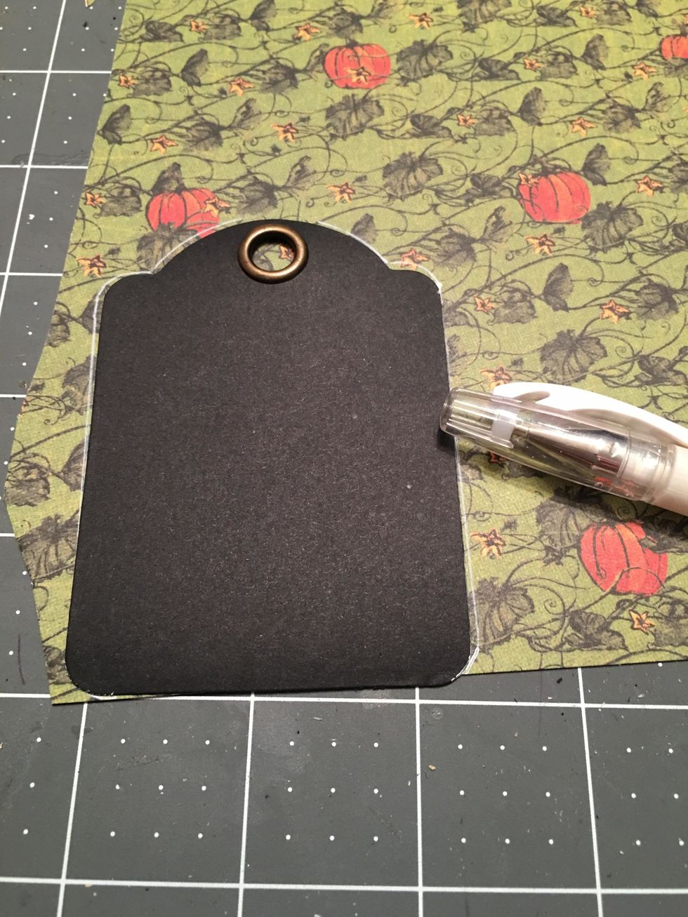 For the ATC tags of the album, you will want to pattern the front and the back of each tag. Lay the tag on to the paper (do not glue down yet) and trace around the tag with a white pen or marker pen.