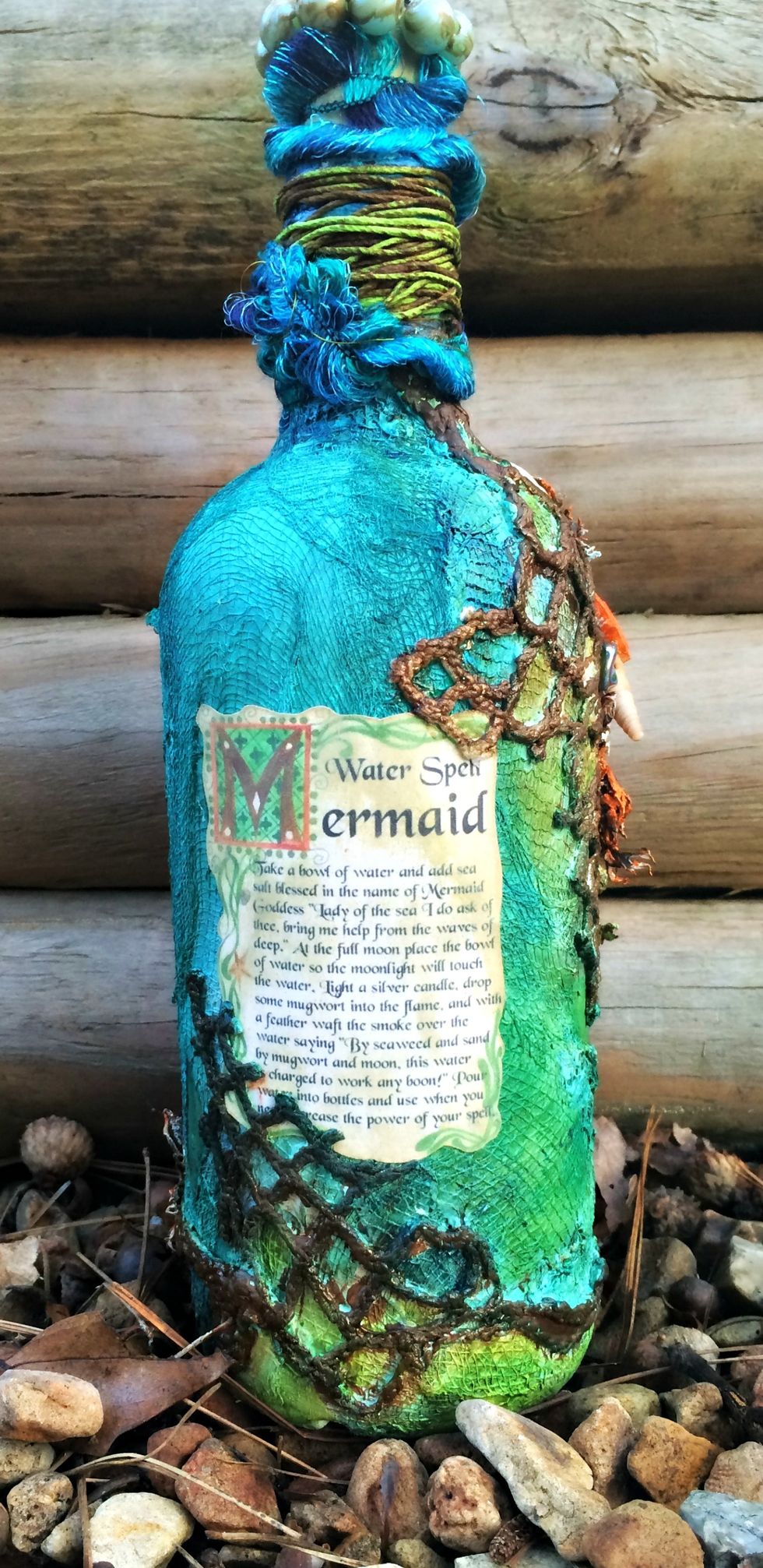 For the back of the bottle I found this cool Mermaid Water Spell and printed it out and glued it to the back. I inked it up a bit to make it look worn