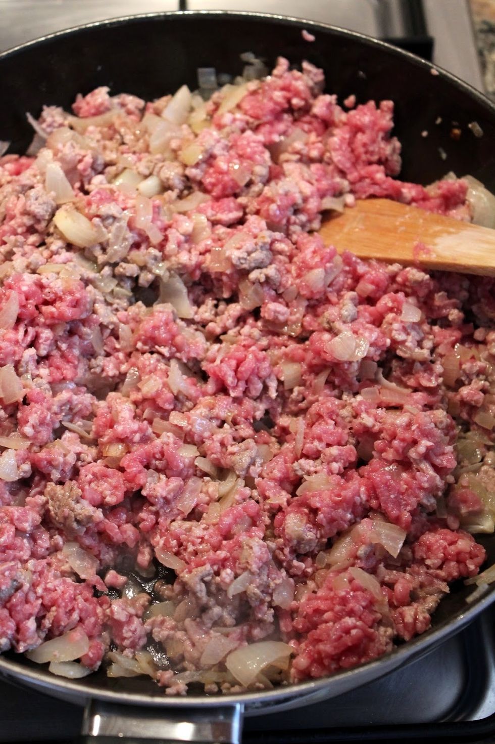For the Bolognese sauce, heat up oil in a large skillet and cast onion. When the onion is golden brown toss the minced meat