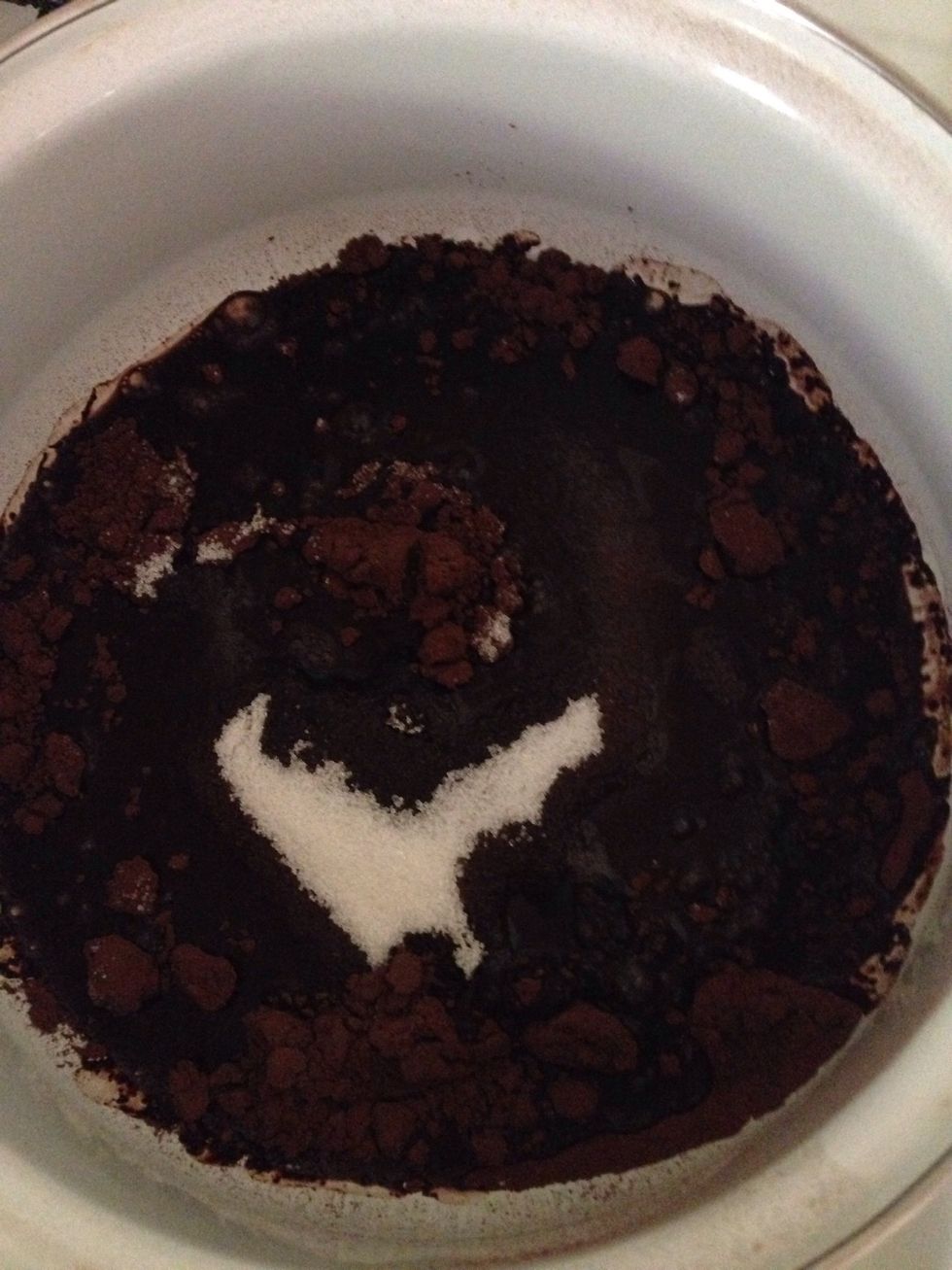 For the cream frosting in a saucepan add cocoa, water, and sugar