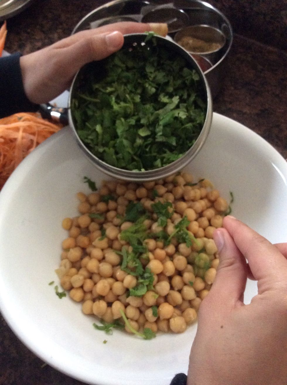 For the dip add coriander leaves for taste . Add two cloves of peeled garlic, 1/2 teaspoon of salt, 1/2 teaspoon of black pepper, 1/2 teaspoon of spice. A bag of coriander leaves is about $1.17.