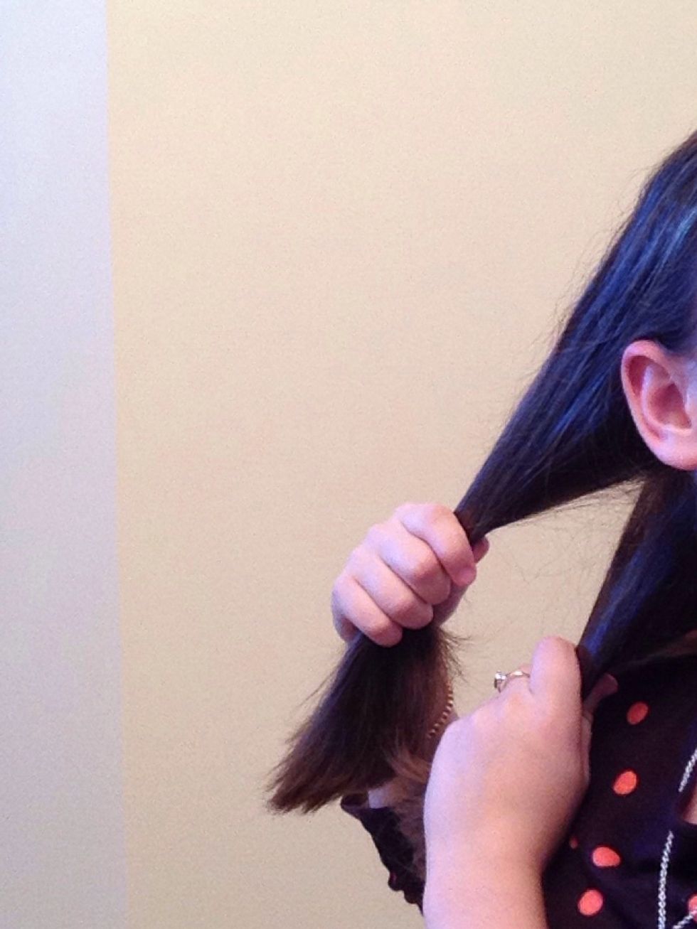 For the first hairstyle, start out by pulling your hair into two separate sections.