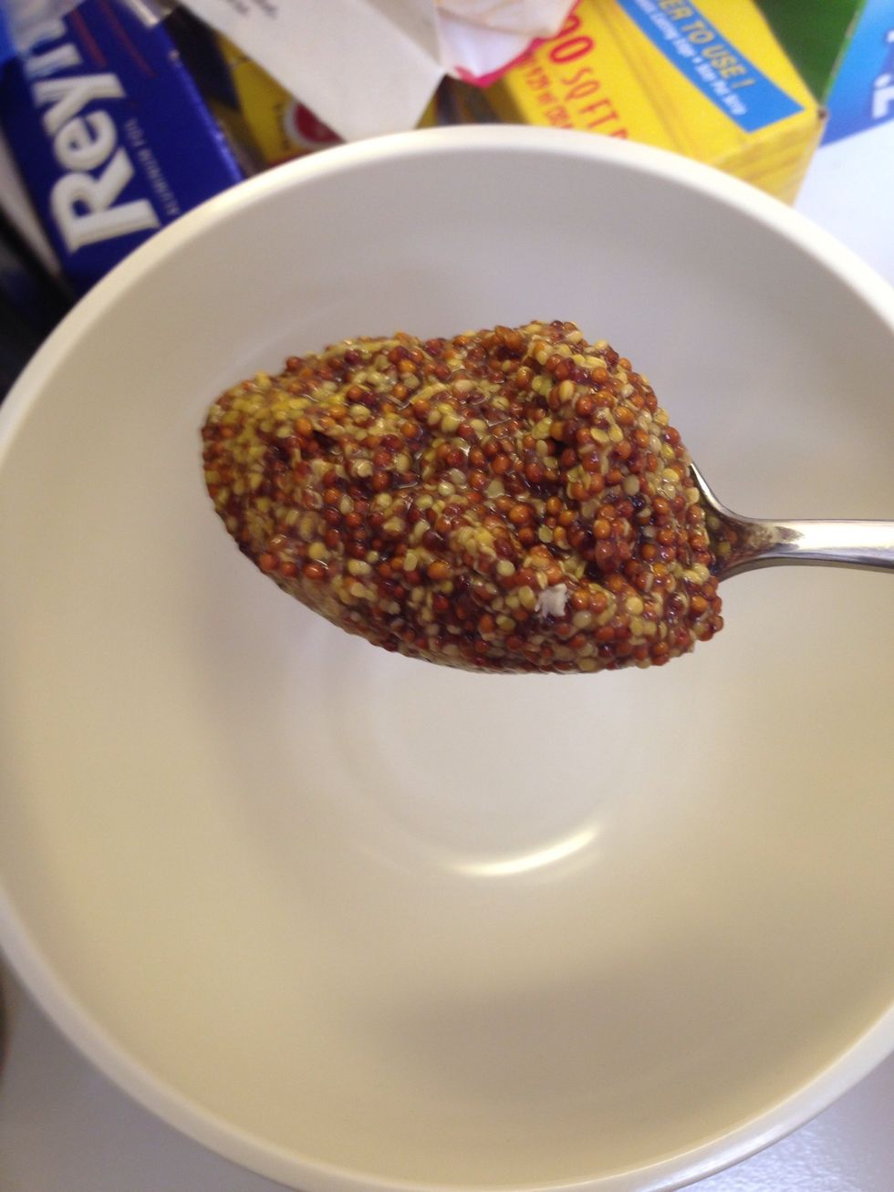 For the glaze. In a small bowl add a tablespoon of grainy mustard. I put in a heaping spoonful because my chicken thighs are large.