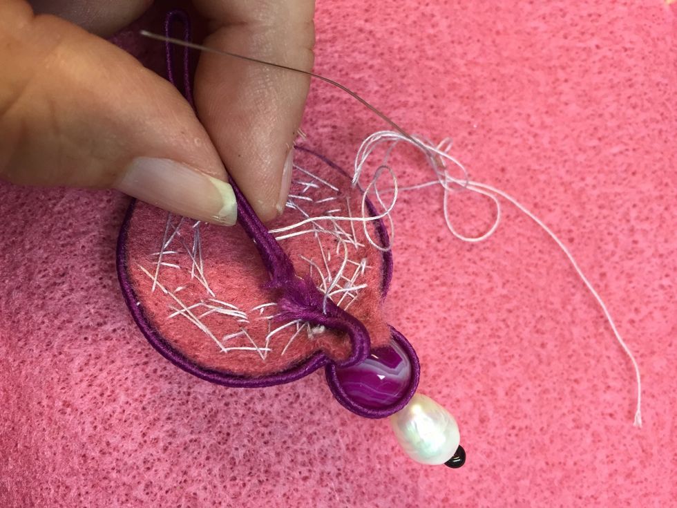 For the hanging part fold 4 inches of cording and stitch to your base