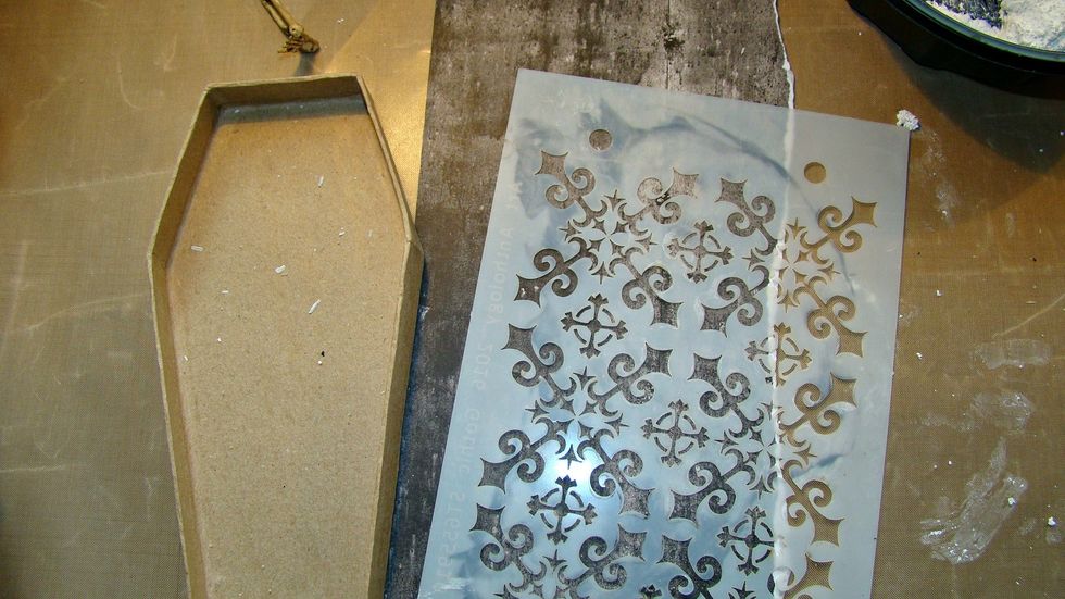 For the inside of the coffin lid I used a Gothic Stencil, ran the texture paste through on to some craft paper and allow to dry, Cut the size of the lid and insert.