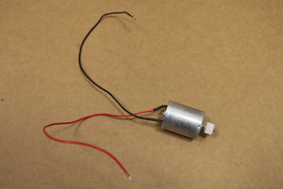 For the motor, get one that uses 6 to 12 DC volts. You might be able to find motors with the eccentric weight online. http://goo.gl/VceFyy