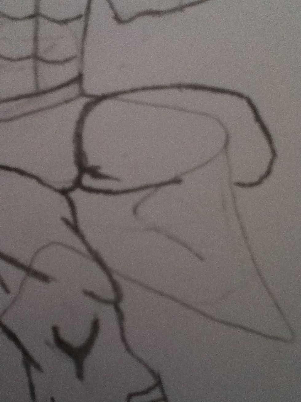 For the other leg draw a large almost oval where the bottom of his leg almost touches his other leg