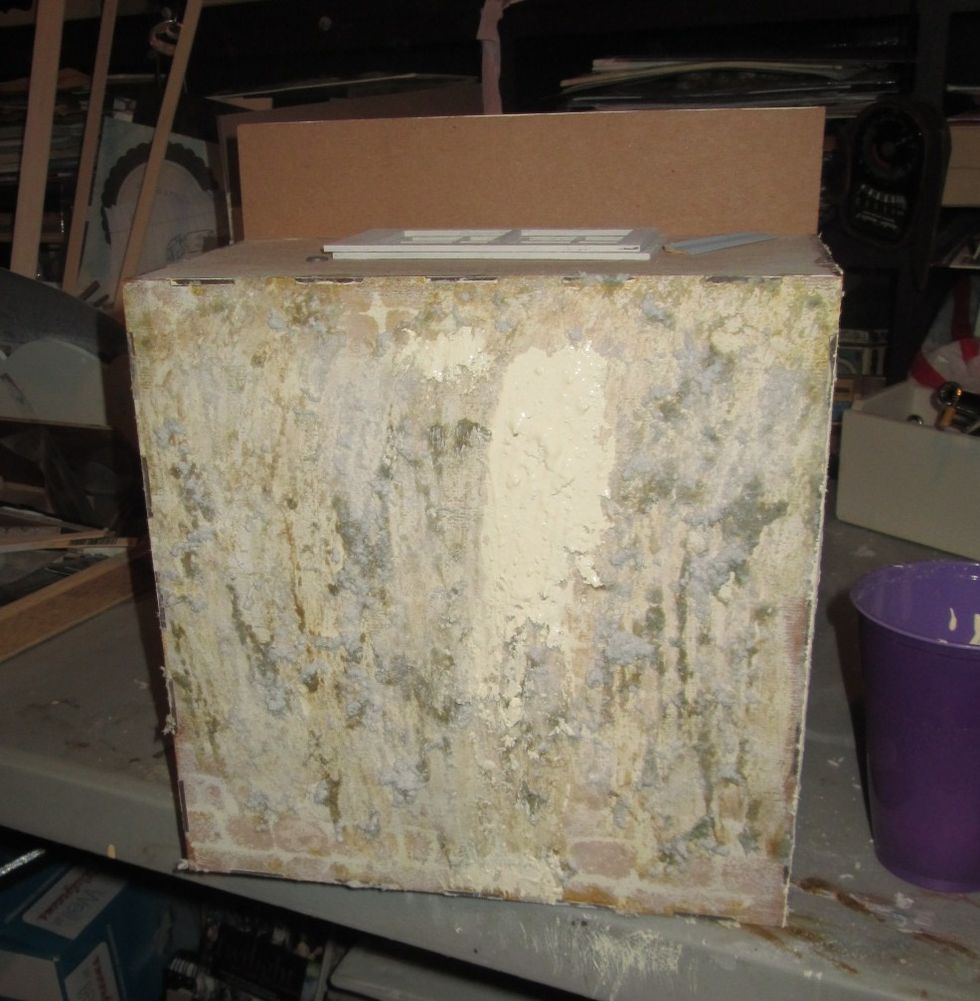 For the outside walls, I wanted a textured look so I used watered down Papier M\u00e2ch\u00e9 and spread it onto the walls.