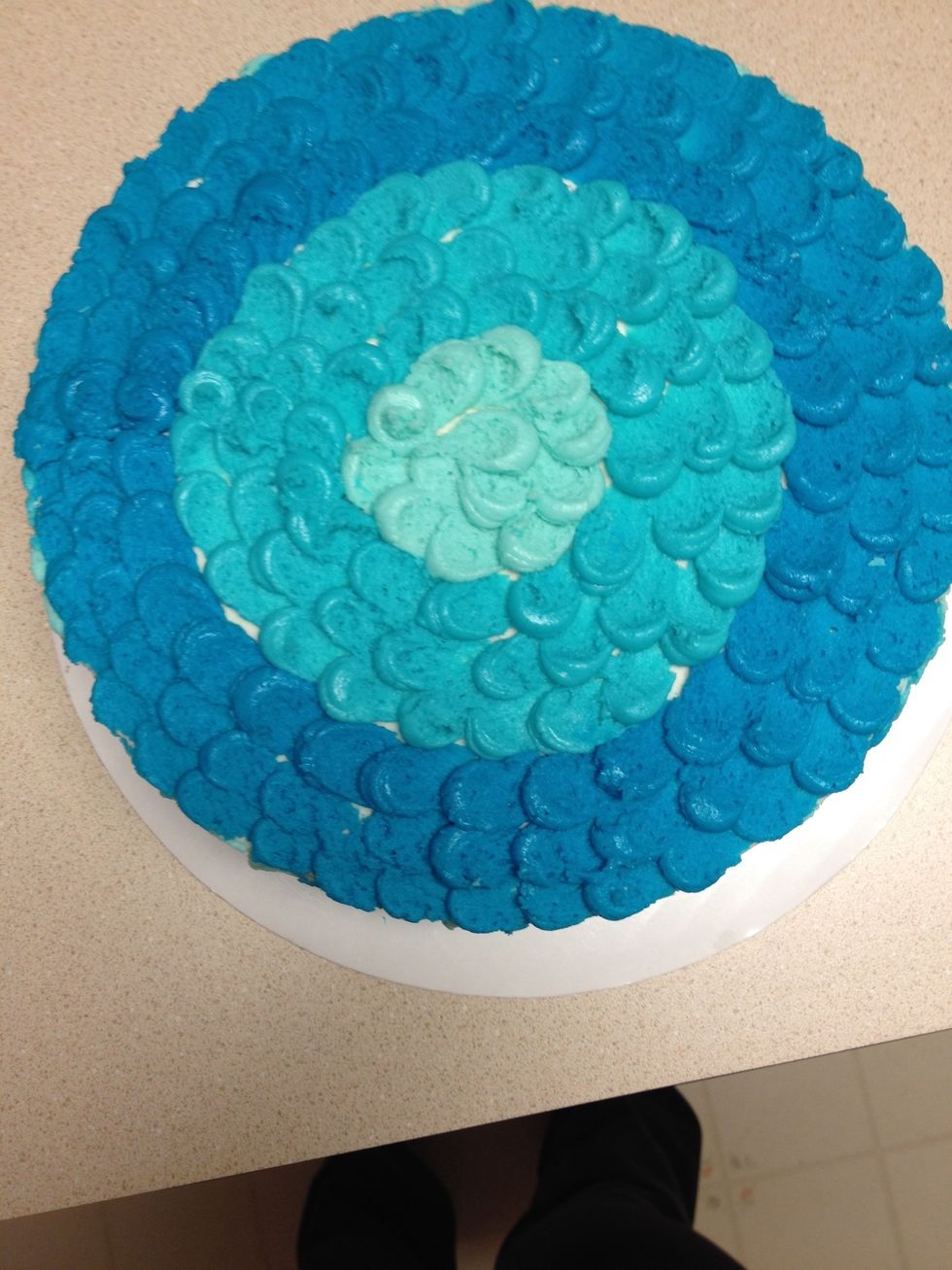 For the top, just pipe three circles of each color using the same pulling technique with the knife