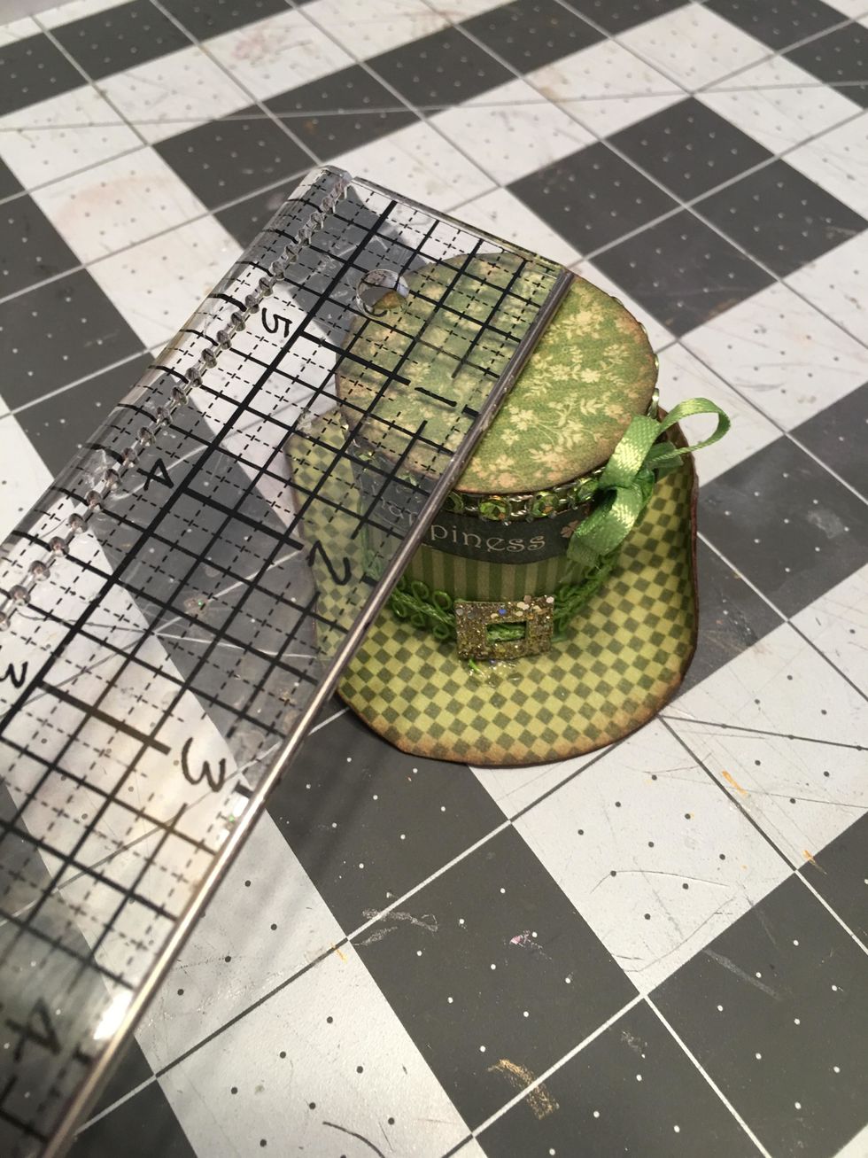 For the top of the hat, measure and cut 1 circle of patterned paper about 1.25" in diameter. Cut a strip of paper the height you want and roll to fit the top of the hat. Glue together into a cylinder