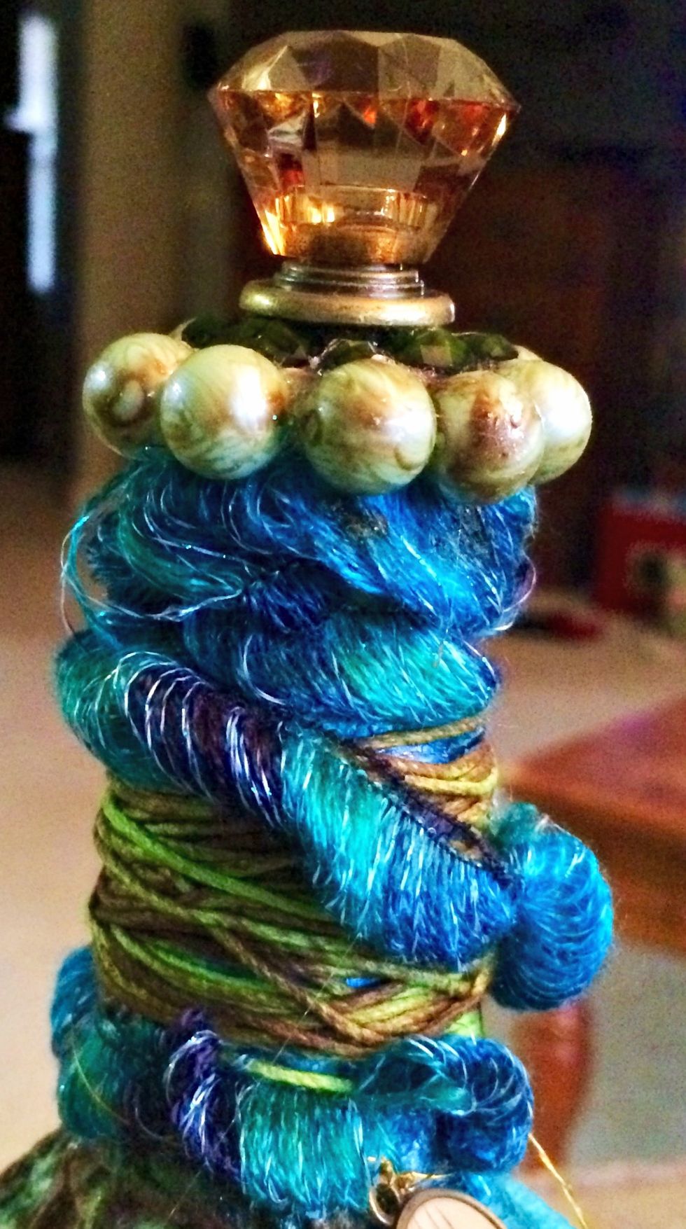 For the topper I got the blue open thread material on clearance at Walmart and also wrapped it with the green hemp cord. I sprayed that with some cinnamon toast tone down the brightness of the green.