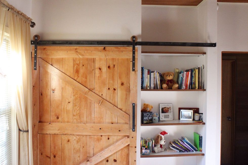 For the track use a piece of black steel that was 4in thick. Place support screws through to the wall evenly spaced and connect to studs.