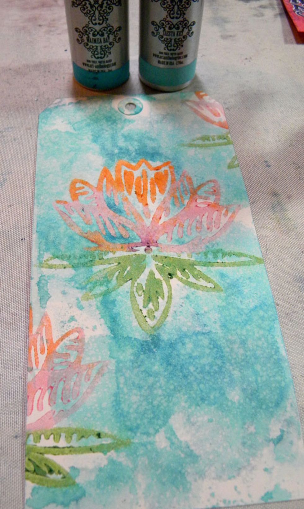 For the water lily, I added Waimea and Siesta Key Colorations Sprays to the background and moved it around with a paint brush. I also stamped with light blue archival ink on the background.