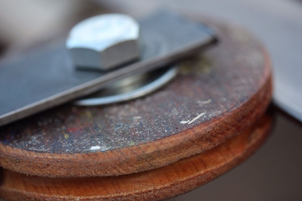 For the wheels use 1/2 inch wood. Use a 2 inch circular drill bit to cut two 4 inch wheels for each side of the door. Cut the center out for the bearings and bolt.