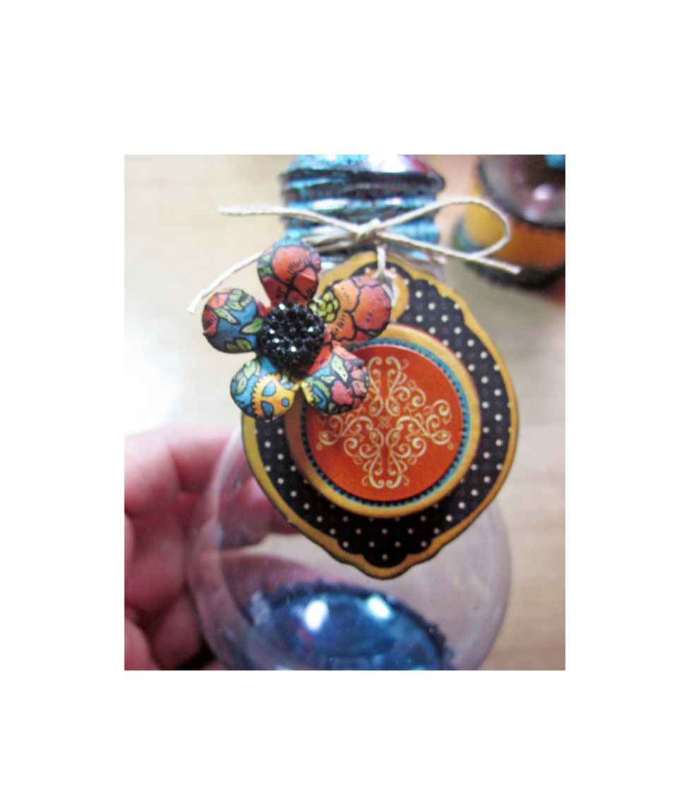 For this mini vase used the Graphic 45 Steampunk Spells stickers, chipboard and flowers to embellish.