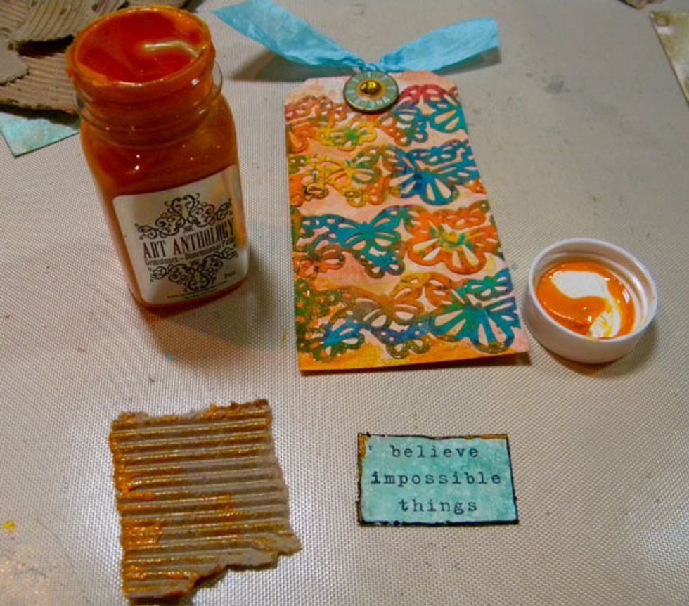 For this tag, I adhered treasures from the hand painted drawer then added Amber Gemstones, stamp, ribbon and large eyelet.